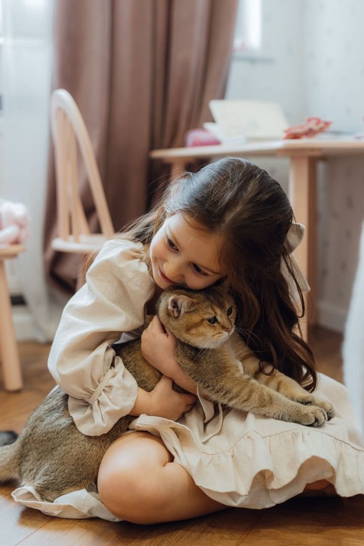 Girl hugging her cat at home